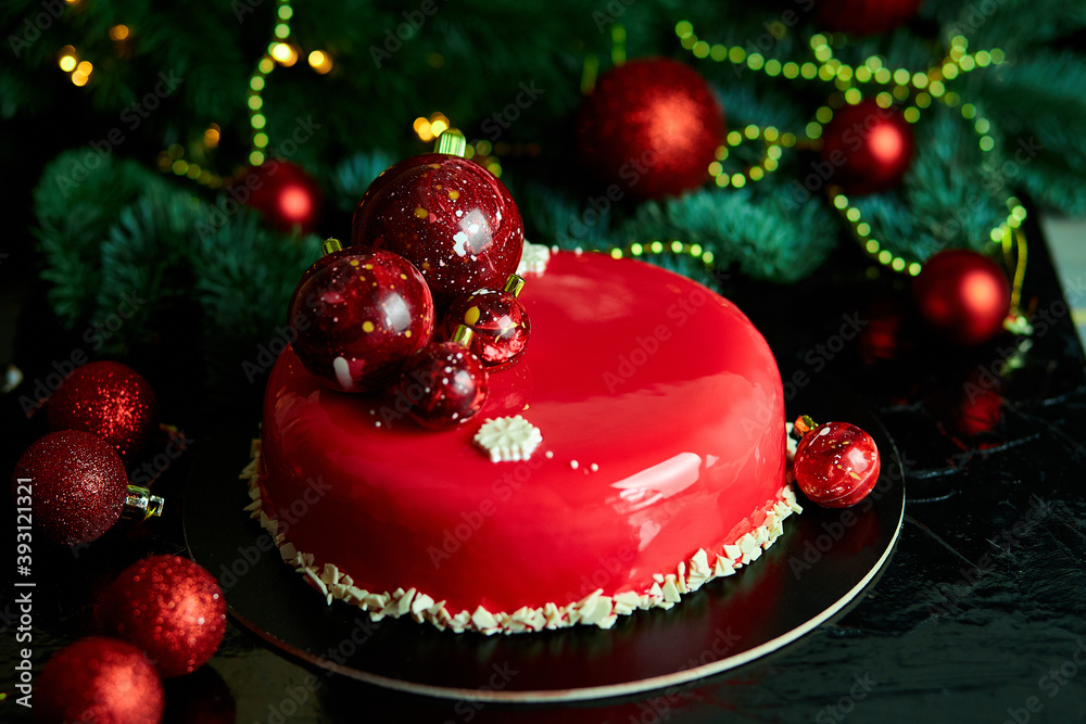 Mousse Christmas pastry cake dessert covered with red mirror glaze with new year decorations