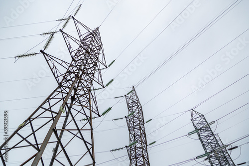 Low angle shot of high voltage powerlines on a gloomy day background photo