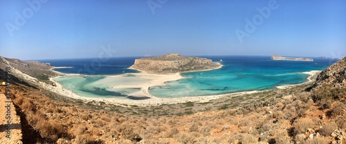 Fantastic panorama of Balos Lagoon and Gramvousa island on Crete, Greece. Balos beach on Crete island, Greece. Tourists relax and bath in crystal clear water of Balos beach.