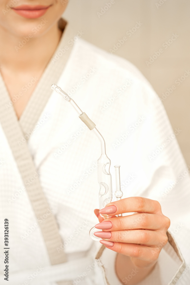 Nasal essential oil inhaler maholda in hands of young woman in spa center Nasal essential oil inhaler maholda in hands of young woman in spa center