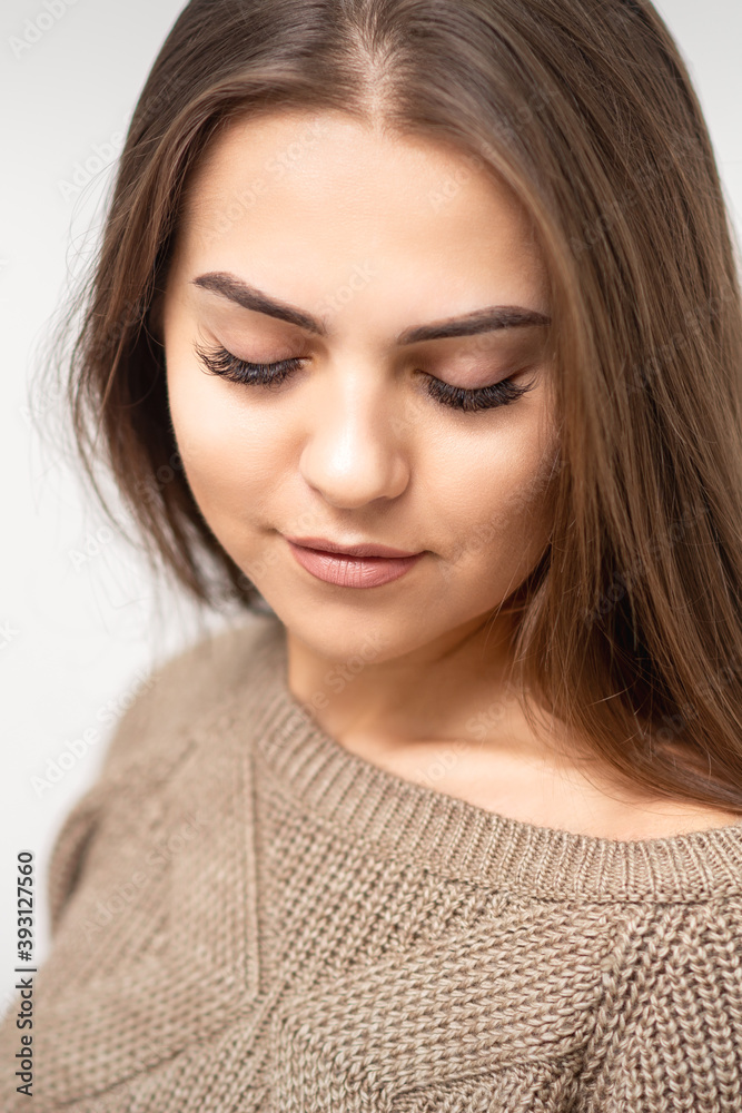 Portrait of beautiful young caucasian woman with closed eyes after eyelash extension procedure and permanent makeup Portrait of beautiful young caucasian woman with closed eyes after eyelash extension procedure and permanent makeup