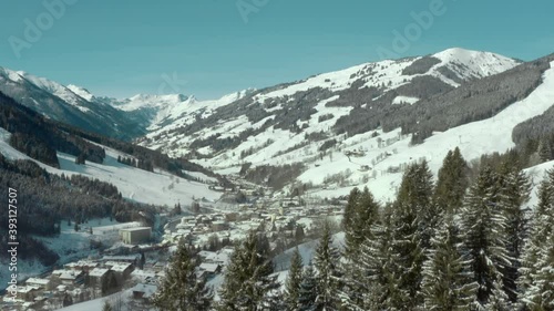 Winter Vacation Concept - Aerial Reveal of Ski Resort in Snowy Mountains photo