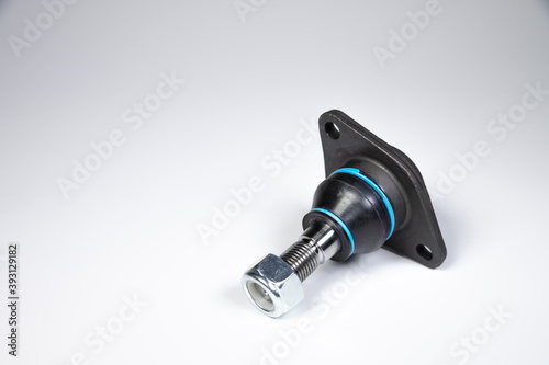 Ball joint car suspension on a gray background. New spare parts axel car elements