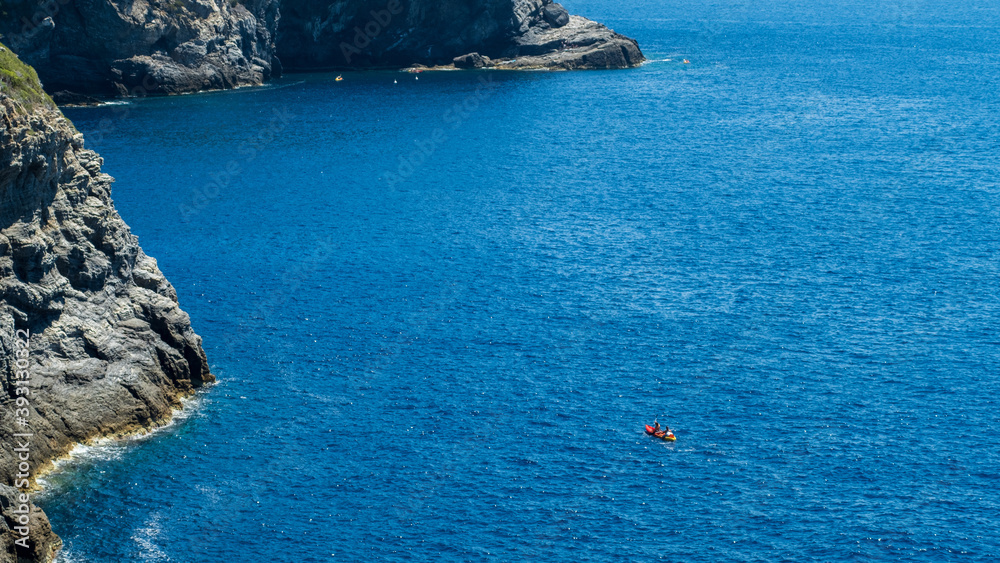 Red Canoe kayaking on the blue Mediterranean sea,