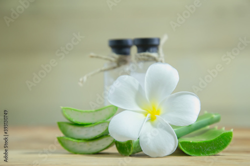 Aloe vera Fresh stacked with drop water and aloe vera juice in glass bowl with honey in jar on old wood