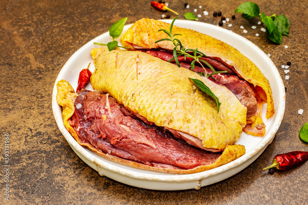 Raw duck breasts with fresh greens and fragrant spices Raw duck breasts with fresh greens and fragrant spices