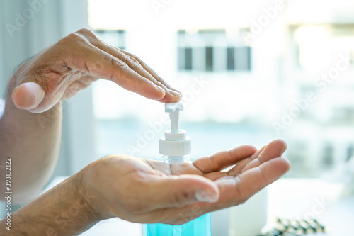 The doctor is pressing alcohol gel to clean hands to stop transmission before and after touching the patient, alcohol gel cleansing concept. And stopping the transmission of infection