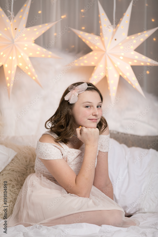 Cute young girls posing on white holiday bed Cute young girls posing on white holiday bed