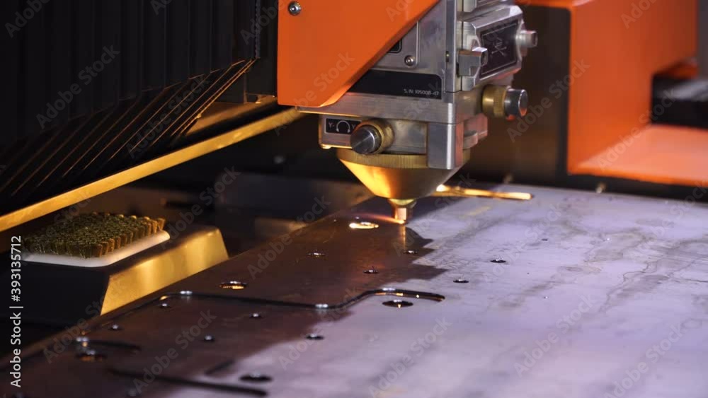 Fiber laser cutting CNC machine cuts metal list close-up. Making metal part.