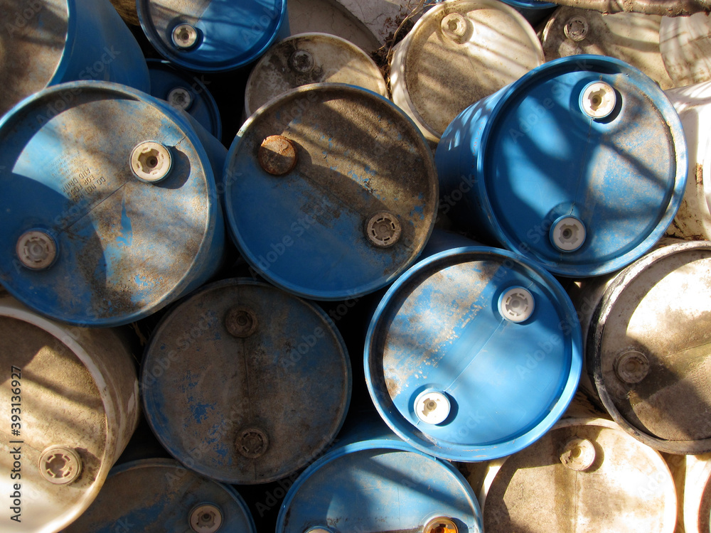 Blue and tan plastic barrels of industrial waste Blue and tan plastic barrels of industrial waste