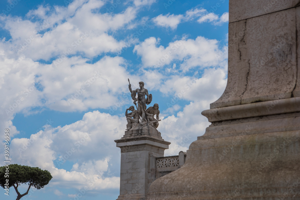 Ancient Roman statue against a cloudy blue sky