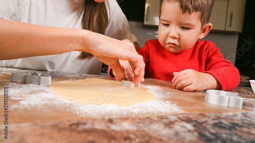 Mom and child make a mold for New Year's cookies