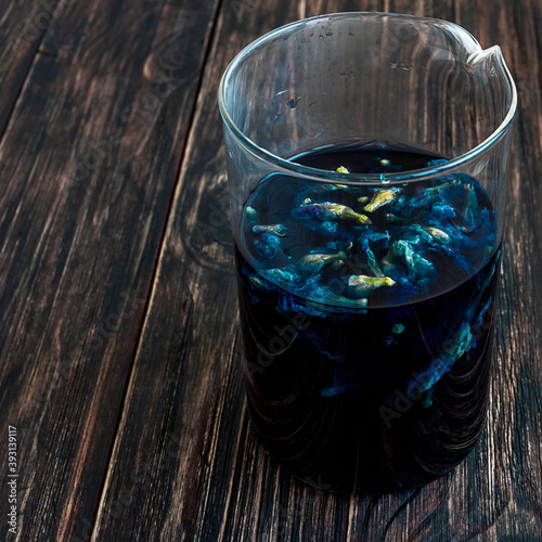 anchan flower herbal blue tea Clitoria Ternatea in a glass beaker photo