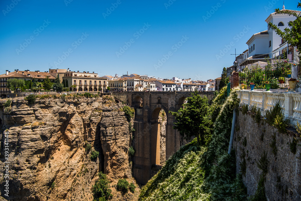 A view of the bridge and the gorge El Tajo of Ronda, on a bright Sunny day