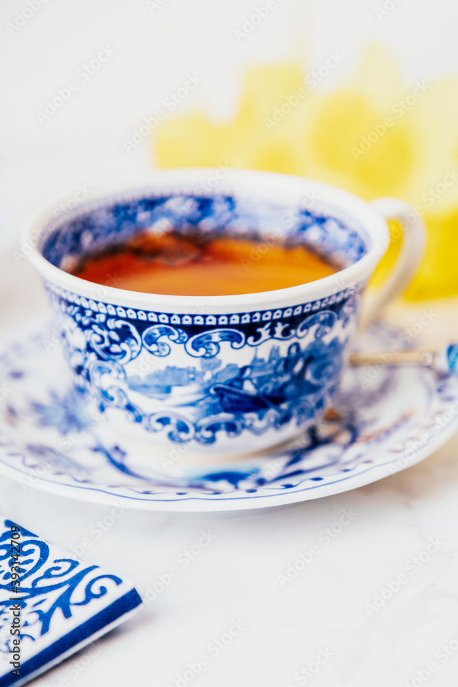A cup of lemon tea with anise star, white and blue dishes. Copy space A cup of lemon tea with anise star, white and blue dishes. Copy space