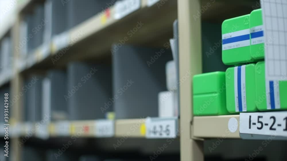 Caucasian Hand Takes Green Rectangle Object from Warehouse Shelving, Close-Up Caucasian Hand Takes Green Rectangle Object from Warehouse Shelving, Close-Up