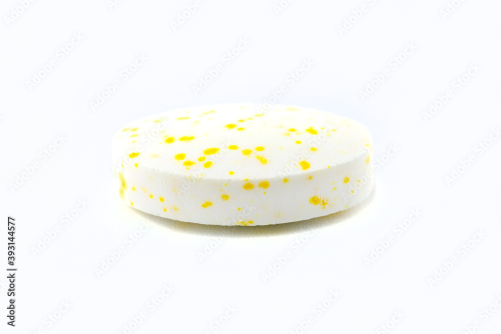 A macro background made of a single white candy with yellow spots. A macro background made of a single white candy with yellow spots.
