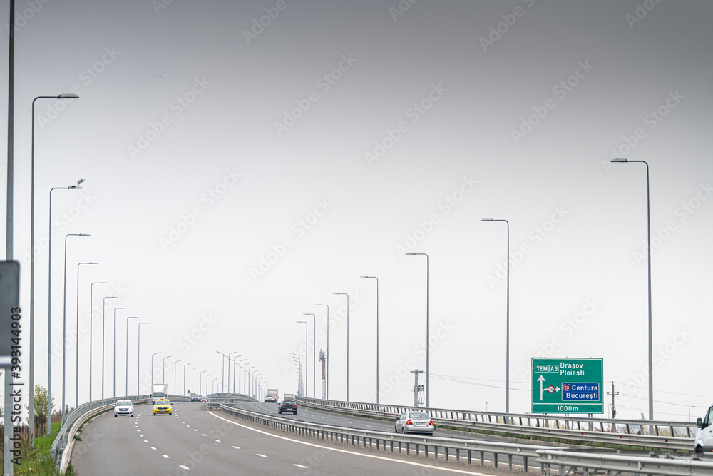 A3 highway motorway road at the entrance in the North of Bucharest city in Romania during a cloudy foggy autumn morning