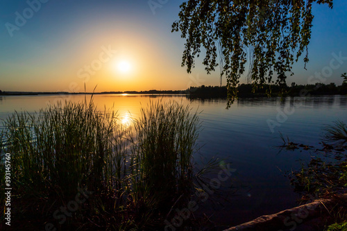 Golden sunset on the lake in Russia. Landscape summer.