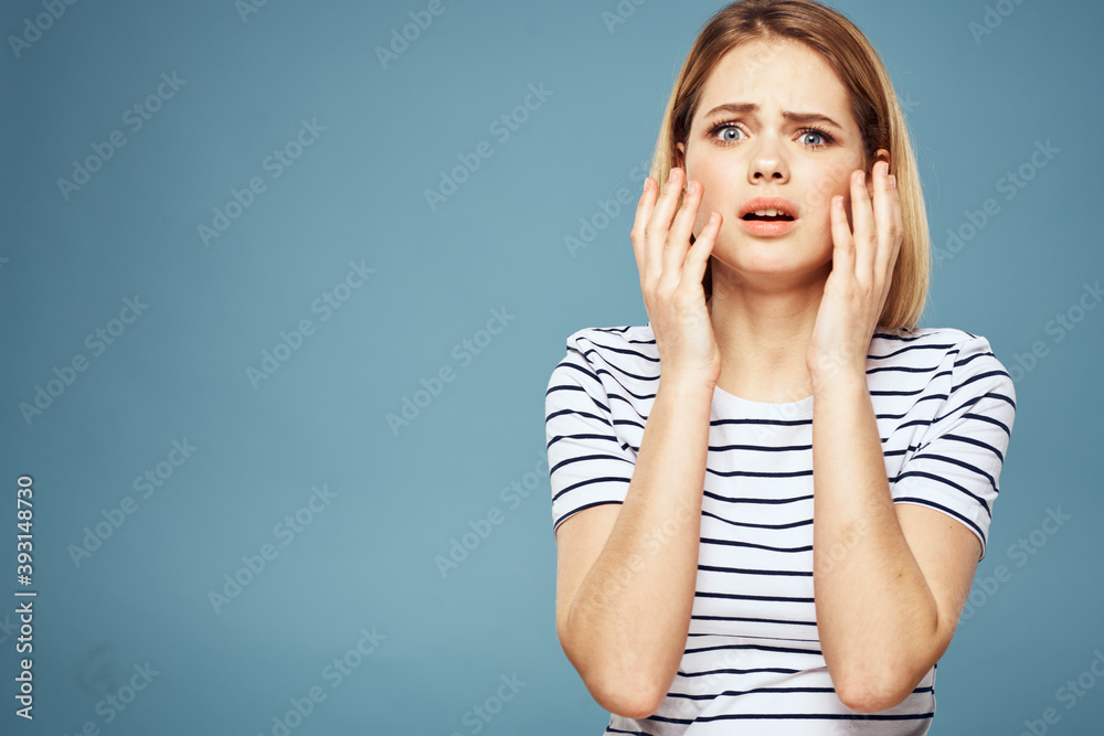 Fototapeta premium Upset woman emotions displeasure gestures with hands blue background