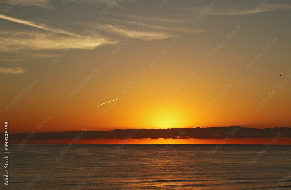 Yellow and red sunrise on the beach, sea landscape