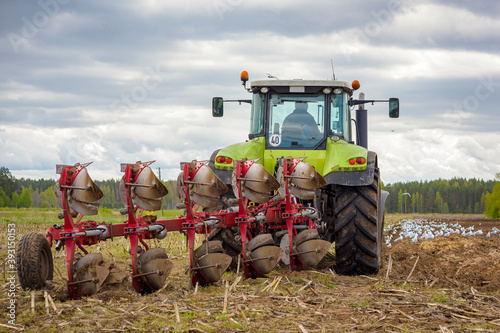 tractor with plough in field photo