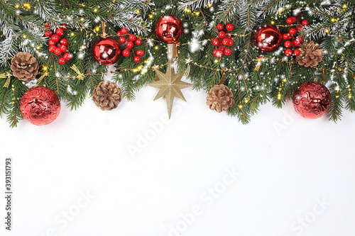Christmas and New Year background with bokeh lights and decorations  toys with fir branches in snow flakes  place for text. Holiday card  selective focus  banner