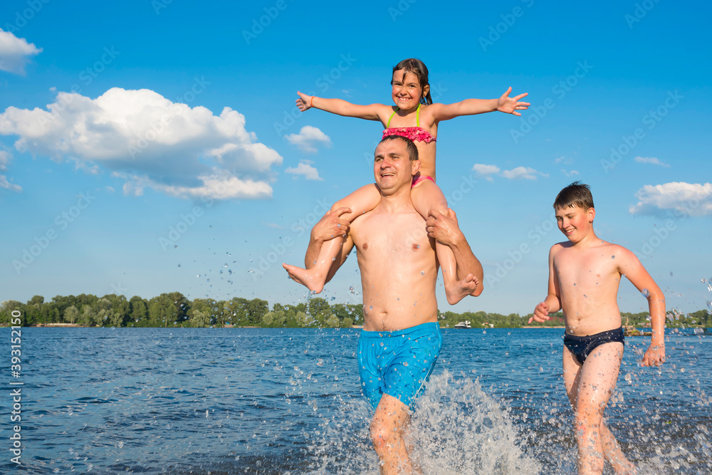 Family water games on vacation. Happy family on the beach, vacation, sports, active lifestyle