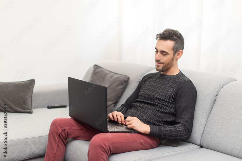 Man working on his laptop pc at home Man working on his laptop pc at home