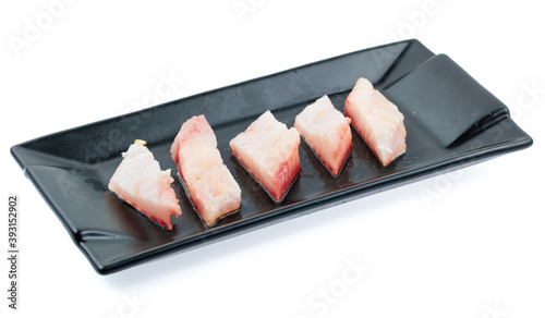 fresh raw fish sliced on square plate isolated on white background, shabu, hot pot ingredients