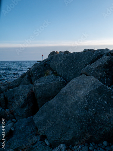 Lighthouse by the Rocks at Sunset