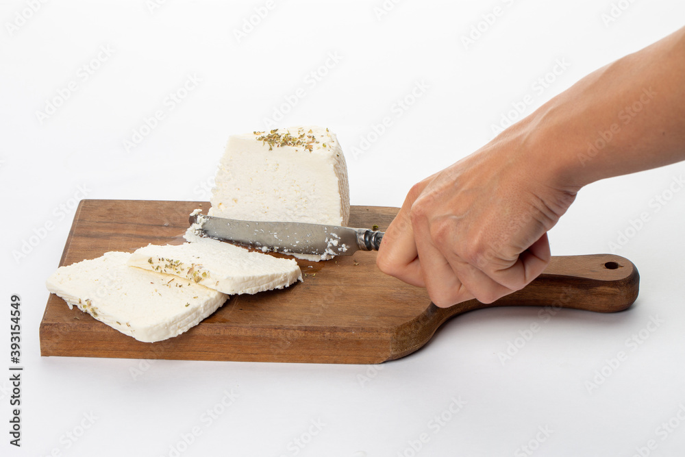 Woman cut white cheese on white background