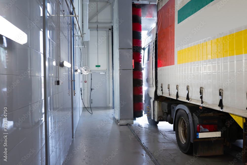 Truck at a car wash using high pressure water with detergents. Keeping trucks clean. Car service Truck at a car wash using high pressure water with detergents. Keeping trucks clean. Car service