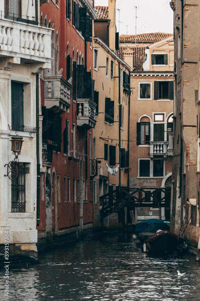 Cityscape of Venice with water canal and old buildings with weathered facade in morning Cityscape of Venice with water canal and old buildings with weathered facade in morning