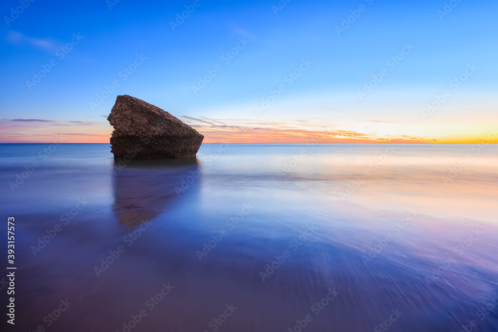 remains of the watchtower known as "Torre de la Higuera" on the shore of Matalascañas beach, (Huelva, Spain) at sunset - obrazy, fototapety, plakaty 