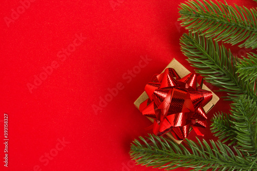  Christmas and New Year background. Gift box on a red background with red packing tape. Concept for Christmas and New Year greetings. Copy space. Top view.