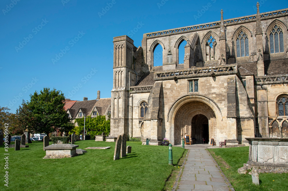 Malmesbury, Wiltshire, England, UK. 2020. The exterior of the 12th century Malmesbury Abbey and graveyard.