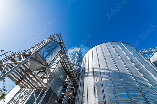 Special grain elevators for crop storage. Metal bridge from the roof of metal tank. View from below. Closeup.