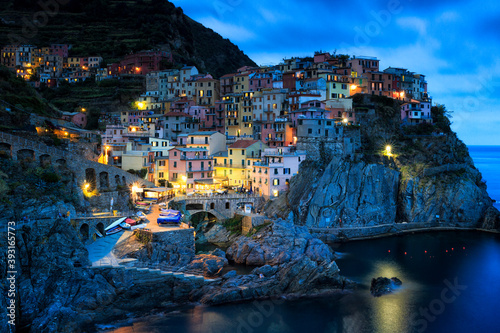 Scenic view of Manarola town on coastline at twilight