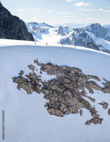 Group of climbers walking across glacier ridge of Howser Towers photo