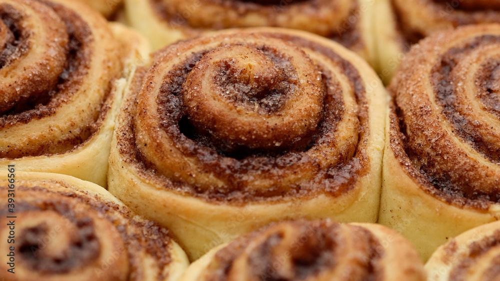 Freshly baked cinnamon rolls close up, top view