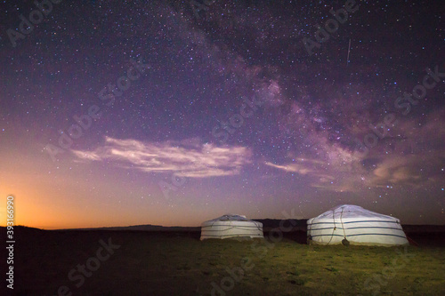 Scenic view of milky way over ger camps on landscape