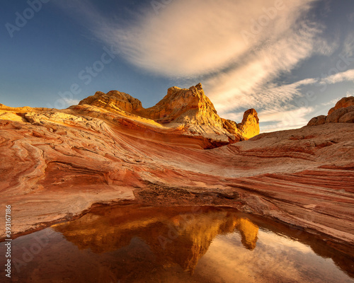 Scenic view of striated sandstone against cloudy sky