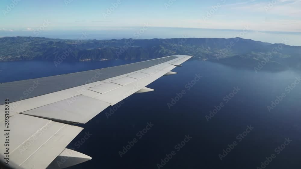 plane wing with São Migel's island in the Azores on the background plane wing with São Migel's island in the Azores on the background