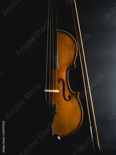 Cropped Image Of Violin Against Black Background photo