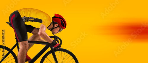 Fototapeta Naklejka Na Ścianę i Meble - Man racing cyclist on yellow background. Man in yellow cycling jersey