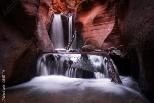 Upper Kanarra Falls in Kanarraville, Utah. A beautiful waterfall scene with red rock in southern Utah. 
