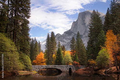 A vibrant fall scene of Half Dome in Yosemite National Park. Autumn colors and Half Dome from Stoneman Bridge.