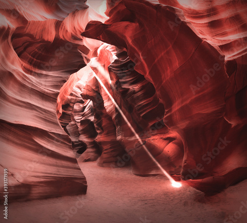 A beam of light shines down in Antelope Canyon, Arizona. A guided tour through a slot canyon on Navajo land near Page.