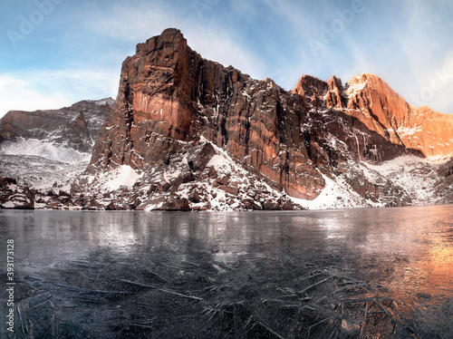 Sunrise at a frozen Chasm Lake in Rocky Mountain National Park in Colorado. 